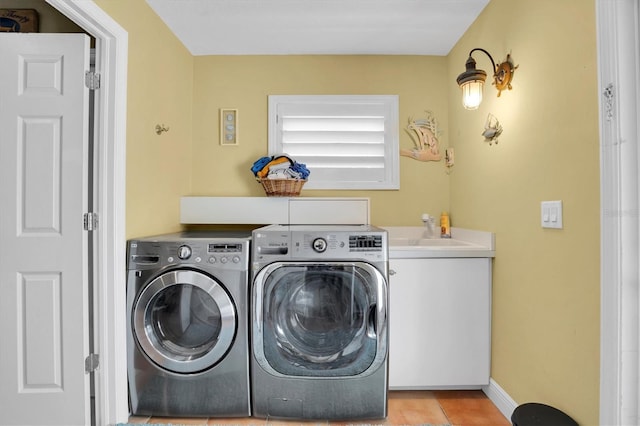 laundry room with cabinets, independent washer and dryer, sink, and light tile patterned floors