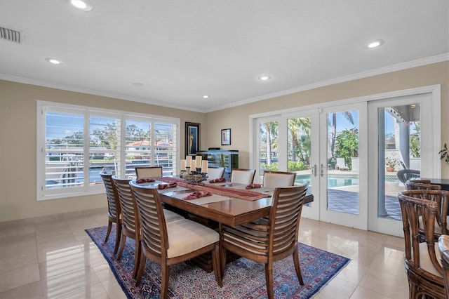 dining space featuring ornamental molding, a healthy amount of sunlight, and french doors