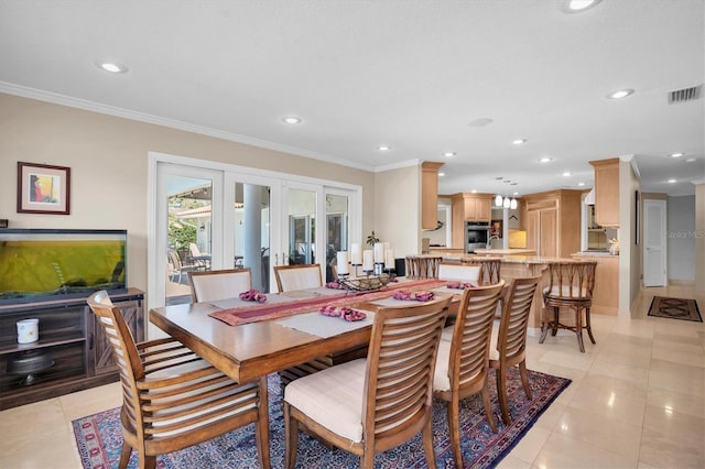 tiled dining room featuring crown molding and french doors