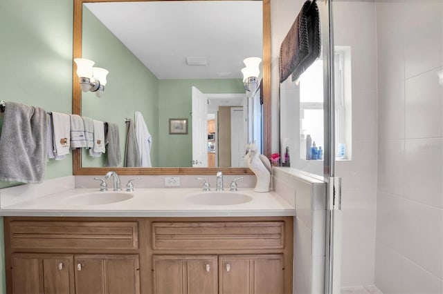 bathroom featuring vanity and a shower with shower door