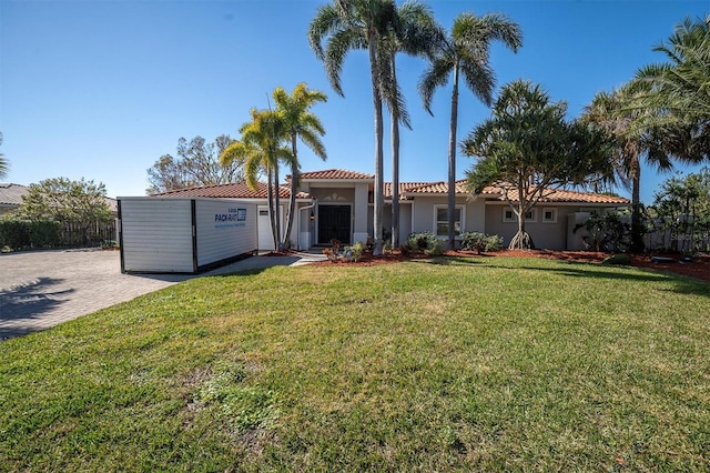 view of front of property featuring a garage and a front lawn