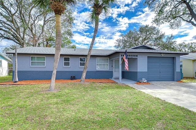 ranch-style house featuring a garage and a front lawn