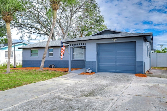 single story home with a garage and a front yard