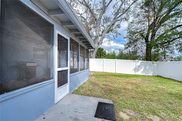 view of yard featuring a patio and a sunroom