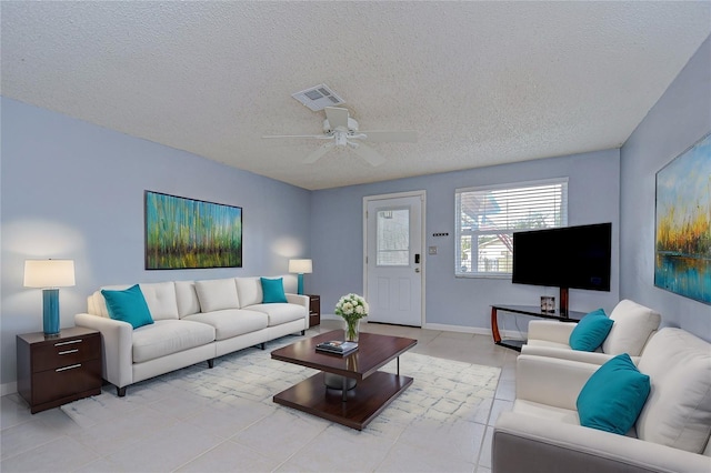 tiled living room with a textured ceiling and ceiling fan