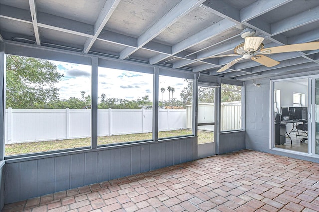 unfurnished sunroom featuring ceiling fan