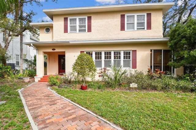 view of front of home featuring a front lawn and stucco siding