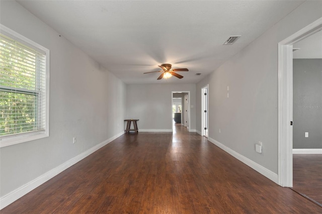 empty room featuring ceiling fan and dark hardwood / wood-style flooring