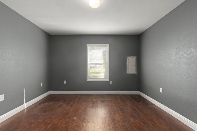 spare room featuring dark hardwood / wood-style flooring