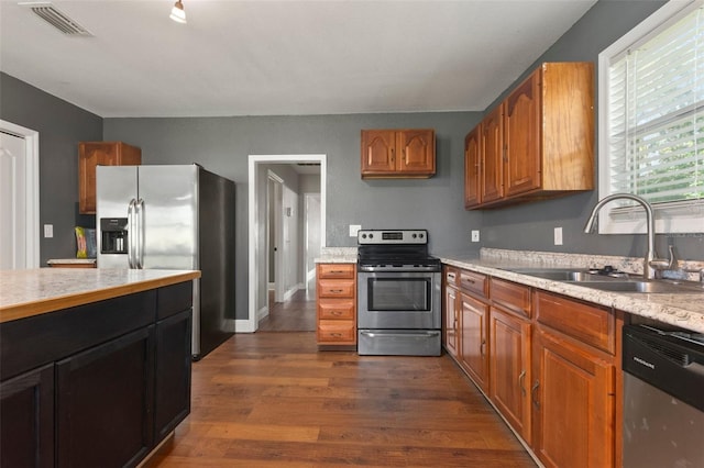 kitchen featuring sink, stainless steel appliances, and dark hardwood / wood-style floors