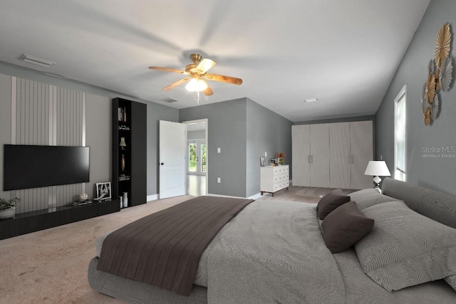 bedroom with carpet flooring, multiple windows, and ceiling fan