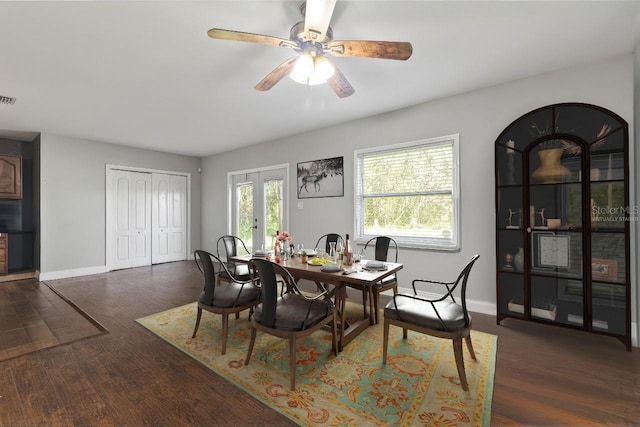 dining space featuring ceiling fan, dark wood-type flooring, and french doors