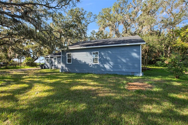 view of side of home featuring a yard