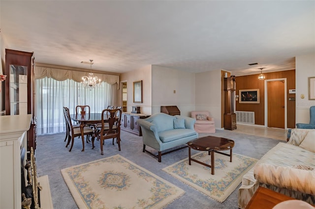 living room with a chandelier and carpet floors