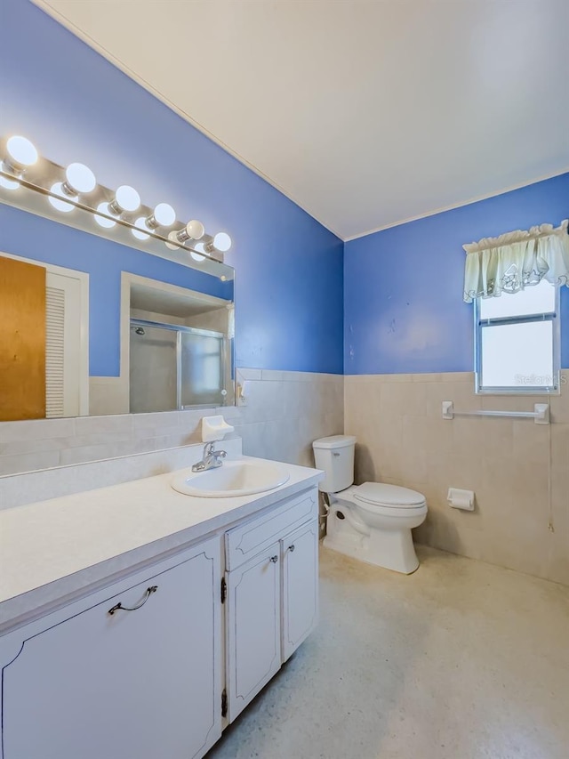 bathroom featuring walk in shower, vanity, tile walls, concrete floors, and toilet