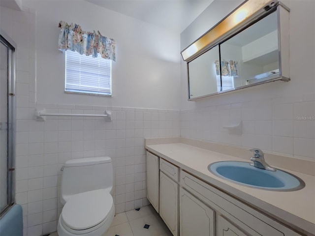 full bathroom featuring vanity, tile patterned floors, combined bath / shower with glass door, toilet, and tile walls