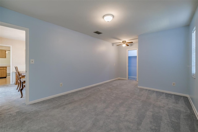 carpeted spare room with ceiling fan