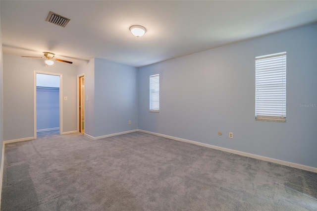 spare room featuring carpet flooring and ceiling fan