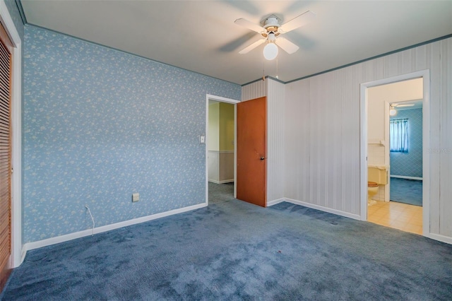 unfurnished bedroom with carpet floors, a closet, ceiling fan, and crown molding