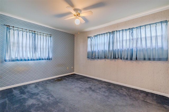 unfurnished room with ceiling fan, a healthy amount of sunlight, crown molding, and dark carpet