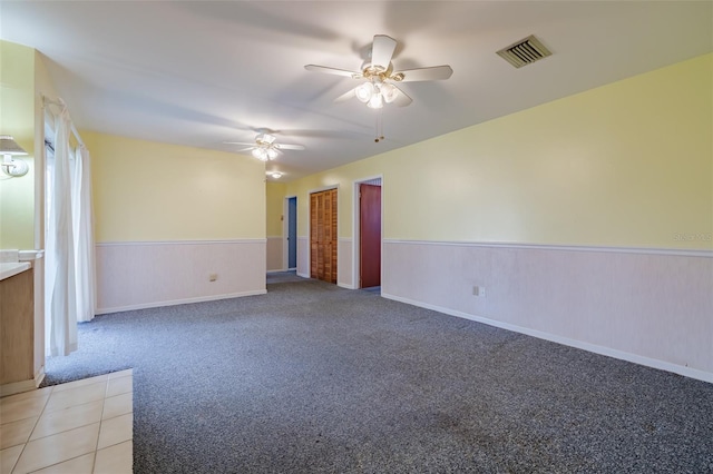 spare room featuring carpet and ceiling fan