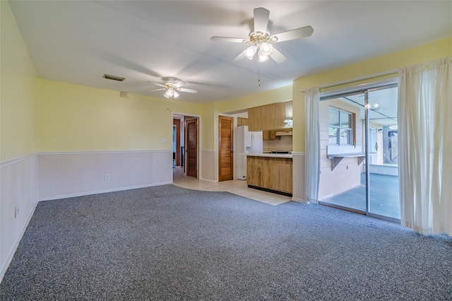 unfurnished living room with light carpet and ceiling fan