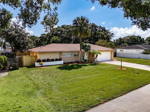 ranch-style house featuring a front yard and a garage