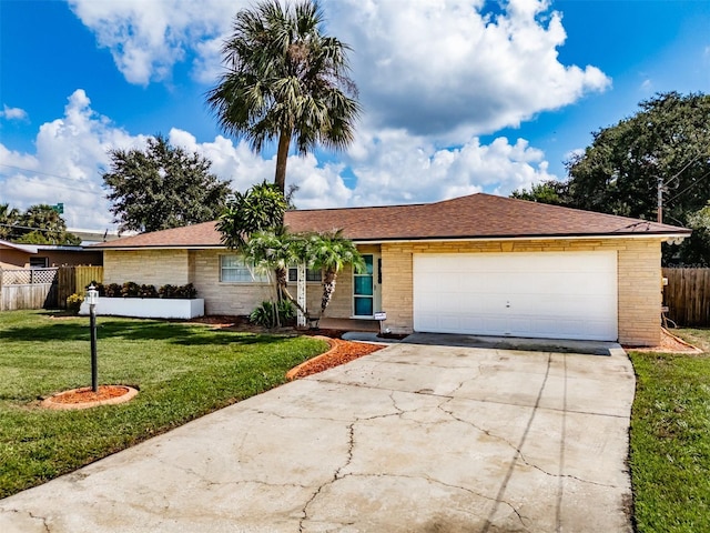 single story home with a garage and a front lawn