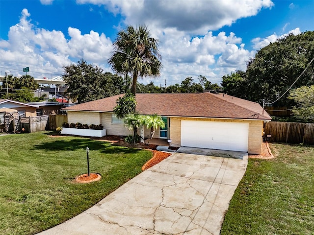 ranch-style home with a garage and a front lawn