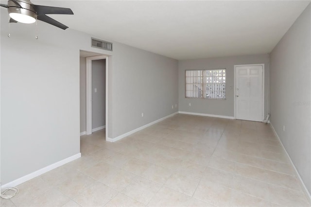 empty room featuring ceiling fan and light tile patterned flooring