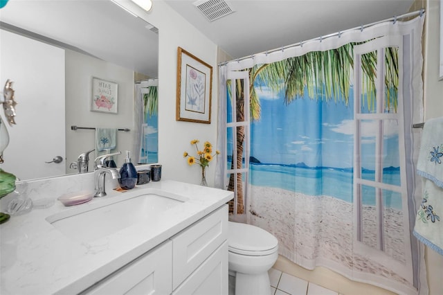 bathroom with toilet, vanity, visible vents, and tile patterned floors