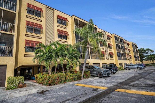 view of building exterior featuring uncovered parking