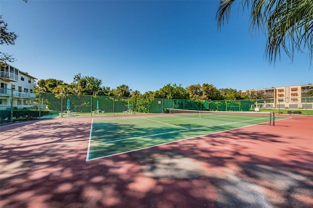 view of tennis court featuring fence