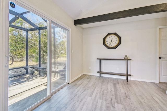 entryway with light hardwood / wood-style flooring and lofted ceiling with beams