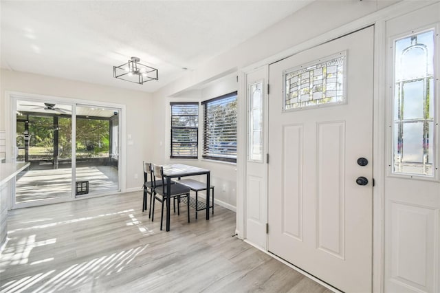 foyer featuring a wealth of natural light, ceiling fan, and light wood-type flooring