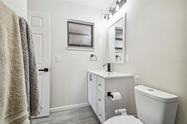 bathroom featuring hardwood / wood-style flooring, vanity, and toilet