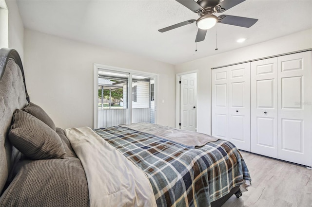 bedroom featuring ceiling fan, a closet, and light wood-type flooring