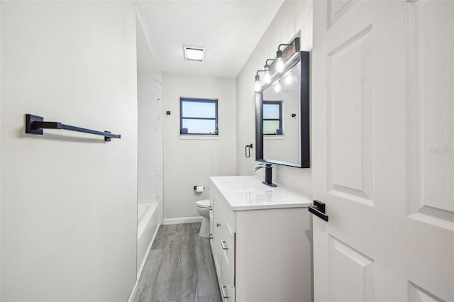 full bathroom featuring wood-type flooring, vanity, toilet, and  shower combination