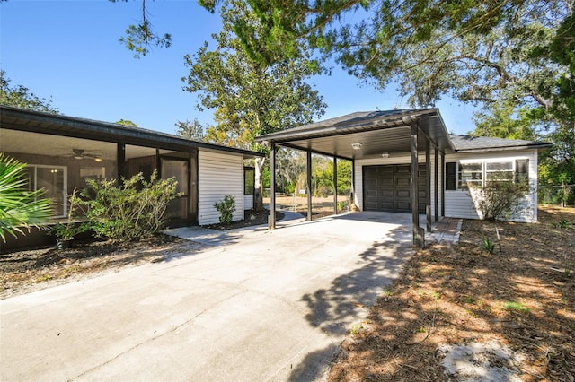 view of home's exterior featuring a carport, ceiling fan, and a garage