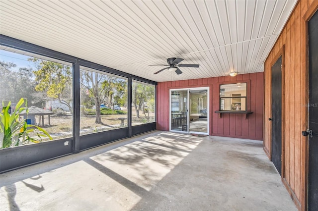 unfurnished sunroom with ceiling fan