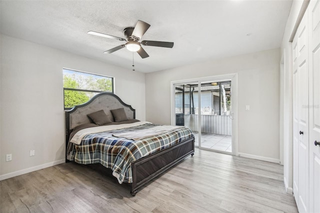 bedroom with access to outside, ceiling fan, light wood-type flooring, a textured ceiling, and a closet