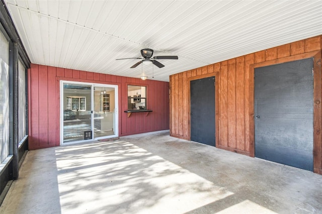 unfurnished sunroom with ceiling fan