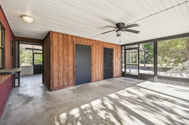 unfurnished sunroom featuring ceiling fan