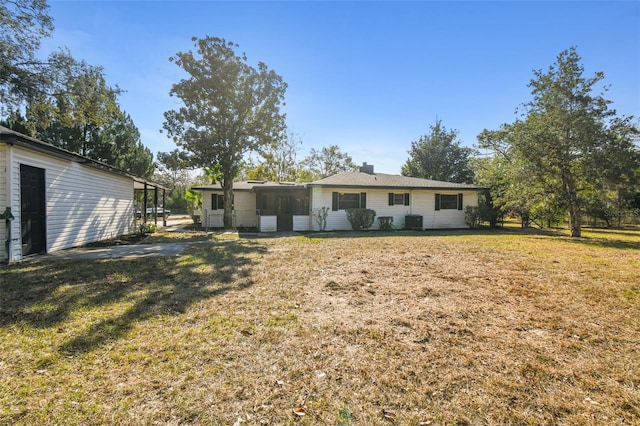 rear view of house featuring a yard