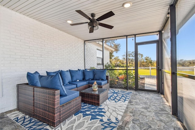 sunroom / solarium featuring ceiling fan