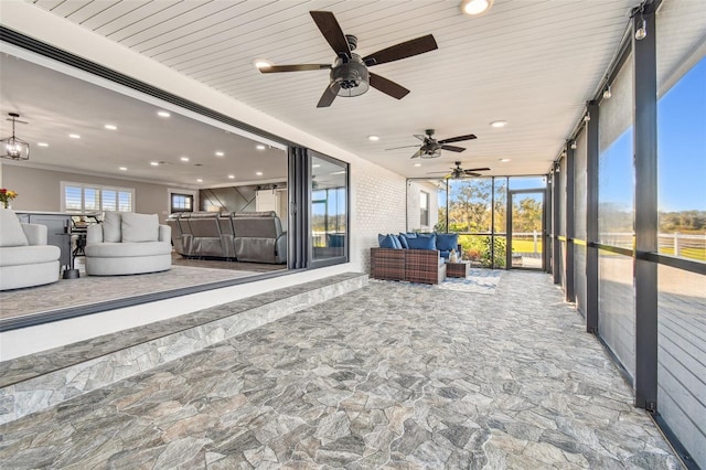 unfurnished sunroom with ceiling fan and wooden ceiling