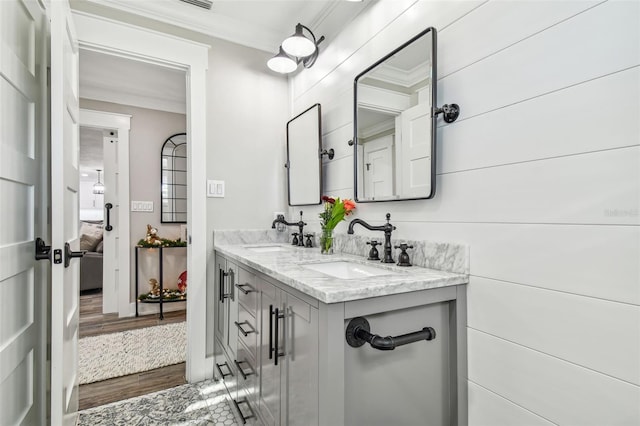 bathroom with hardwood / wood-style flooring, vanity, and ornamental molding