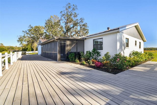 wooden deck with a sunroom