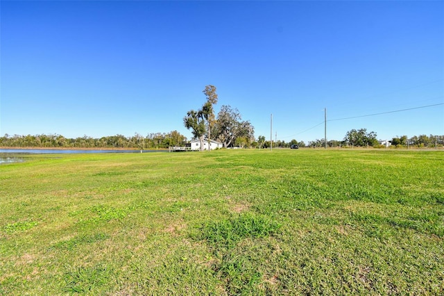 view of yard with a rural view and a water view