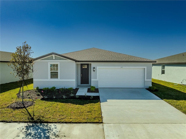 single story home featuring a garage and a front lawn